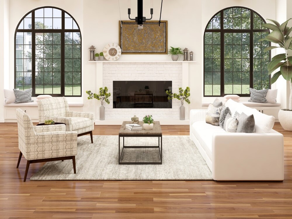 a modern room with a large rug as the centrepiece, including a coffee table, a sofa, and two lounge chairs placed on the rug