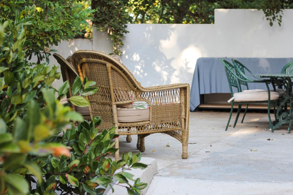 an image of an outdoor patio with a rattan chair on it