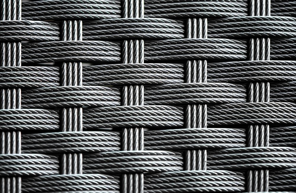 a close up detailed shot of the weave on a rattan chair