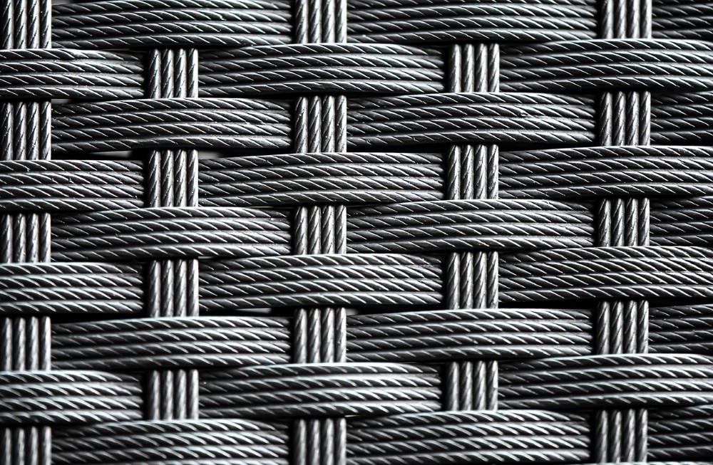 a close up detailed shot of the weave on a rattan chair